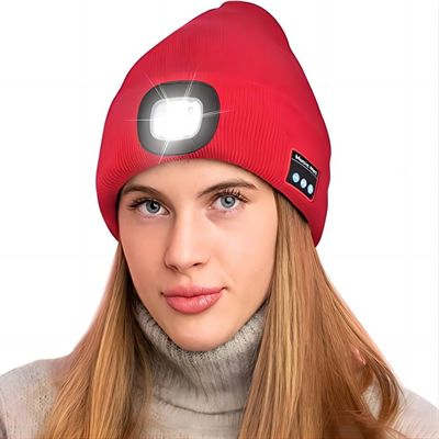 O chapéu sem fio do fones de ouvido do tampão do farol do diodo emissor de luz ilumina sua maneira, música de escuta